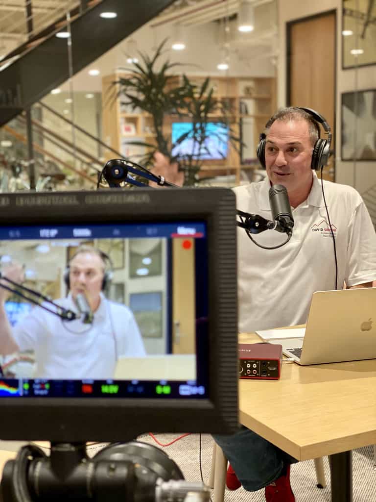 David Sidoni Podcasting In Background Of Camera Monitor